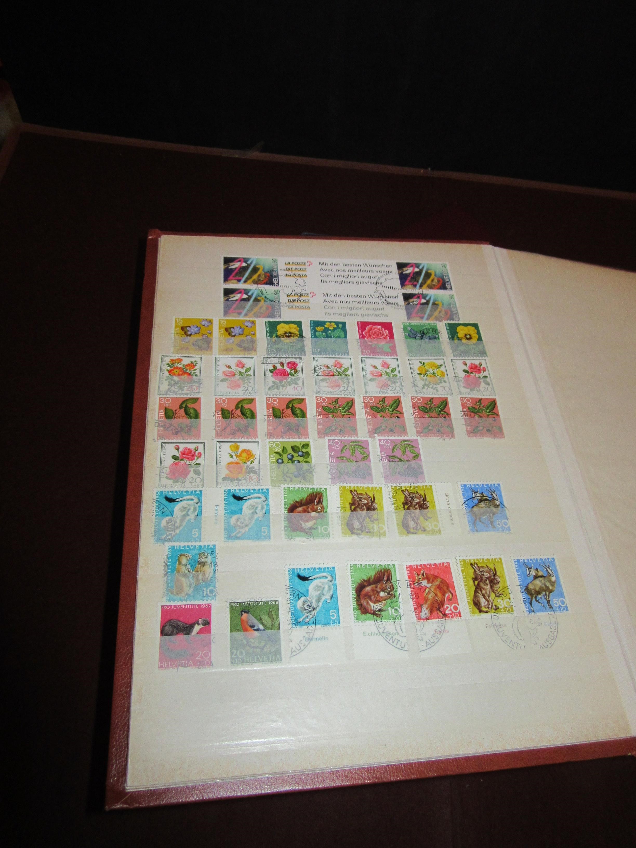 THREE ALBUMS OF SWISS STAMPS Image