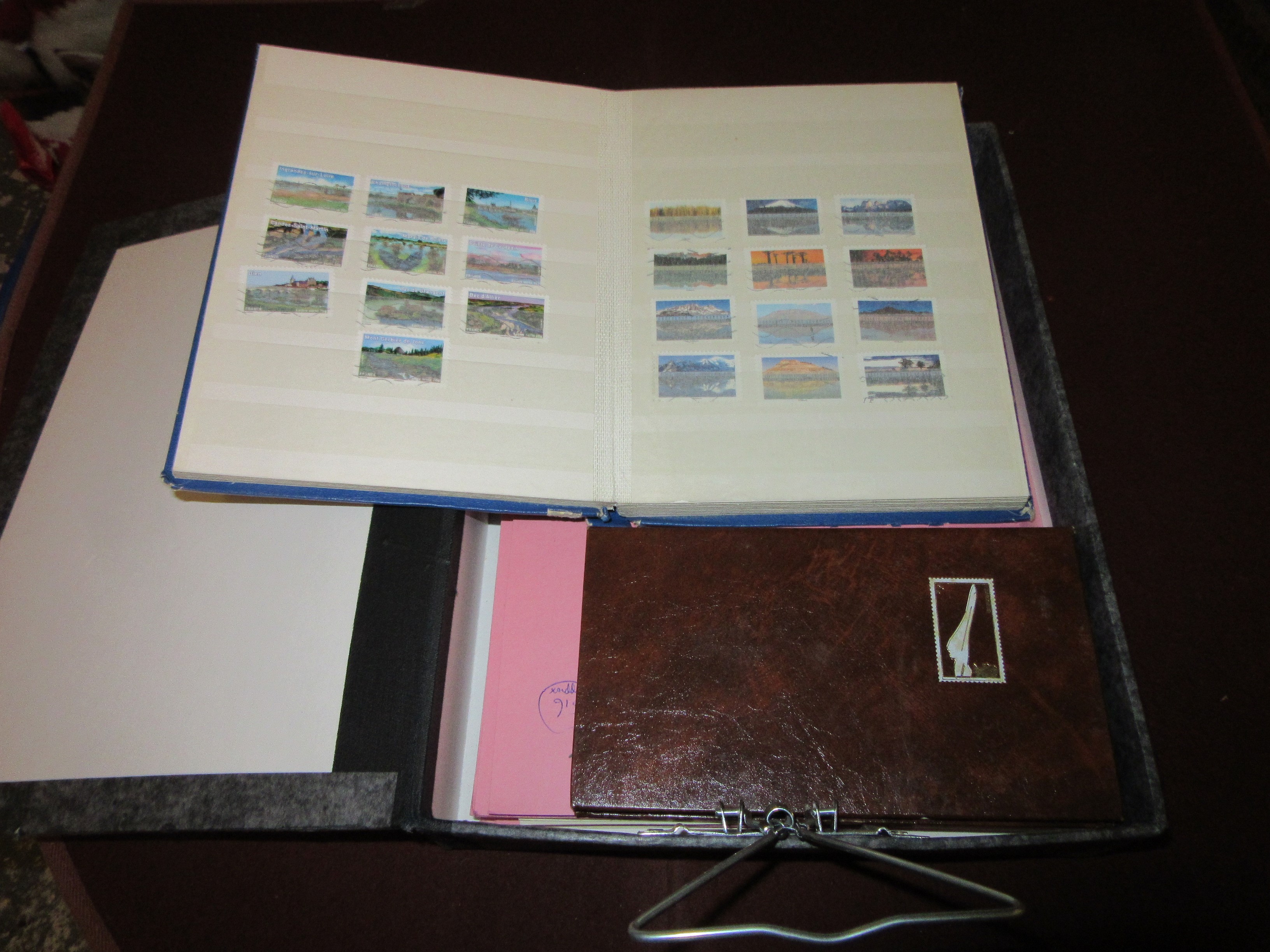 FOLDER OF SWISS STAMPS WITH SMALL STAMP ALBUMS Image