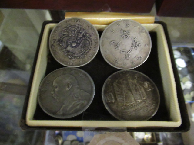 FOUR SILVER CHINESE COINS Image