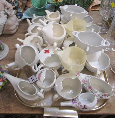 TRAY OF INVALID FEEDING CUPS Image
