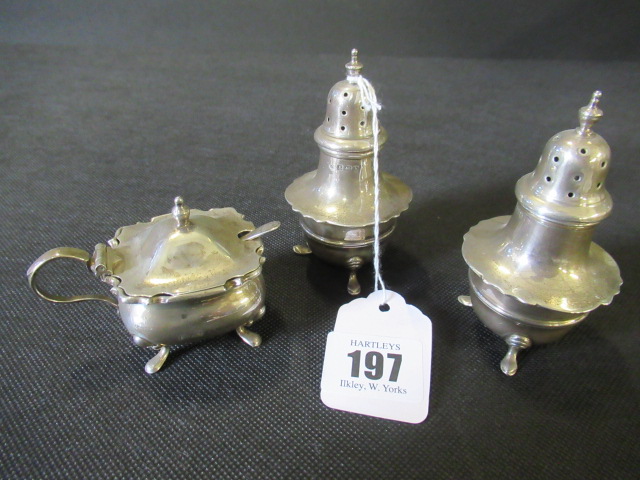 TWO SILVER PEPPERETTES AND A SILVER MUSTARD POT Image