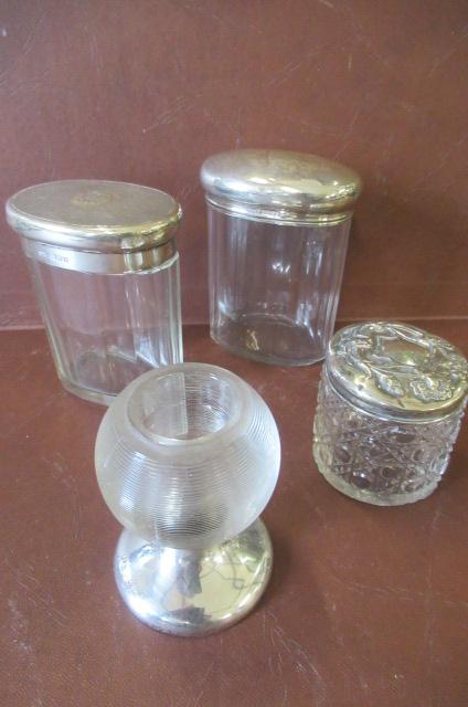 THREE SILVER TOPPED GLASS BOTTLES AND A MATCH STRIKE Image