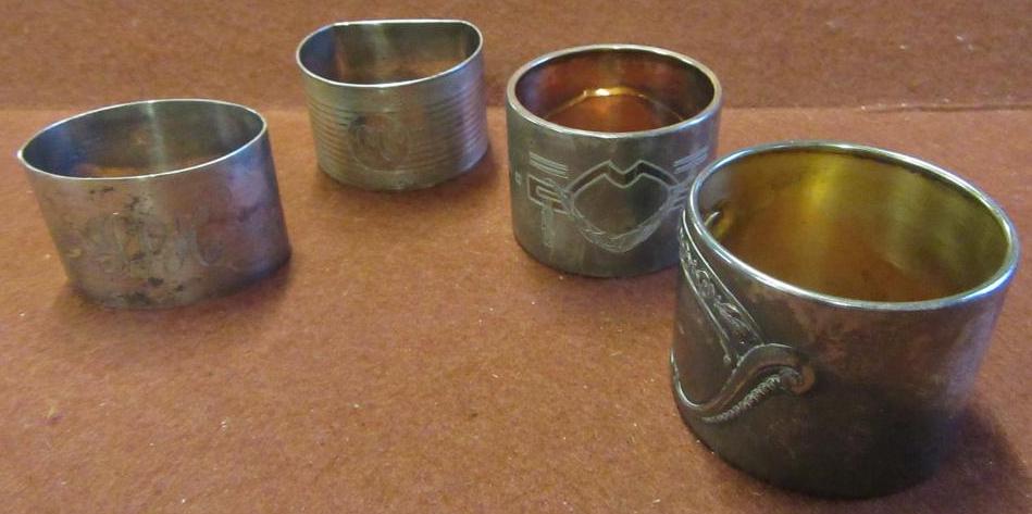 TWO SILVER AND TWO OTHER NAPKIN RINGS Image