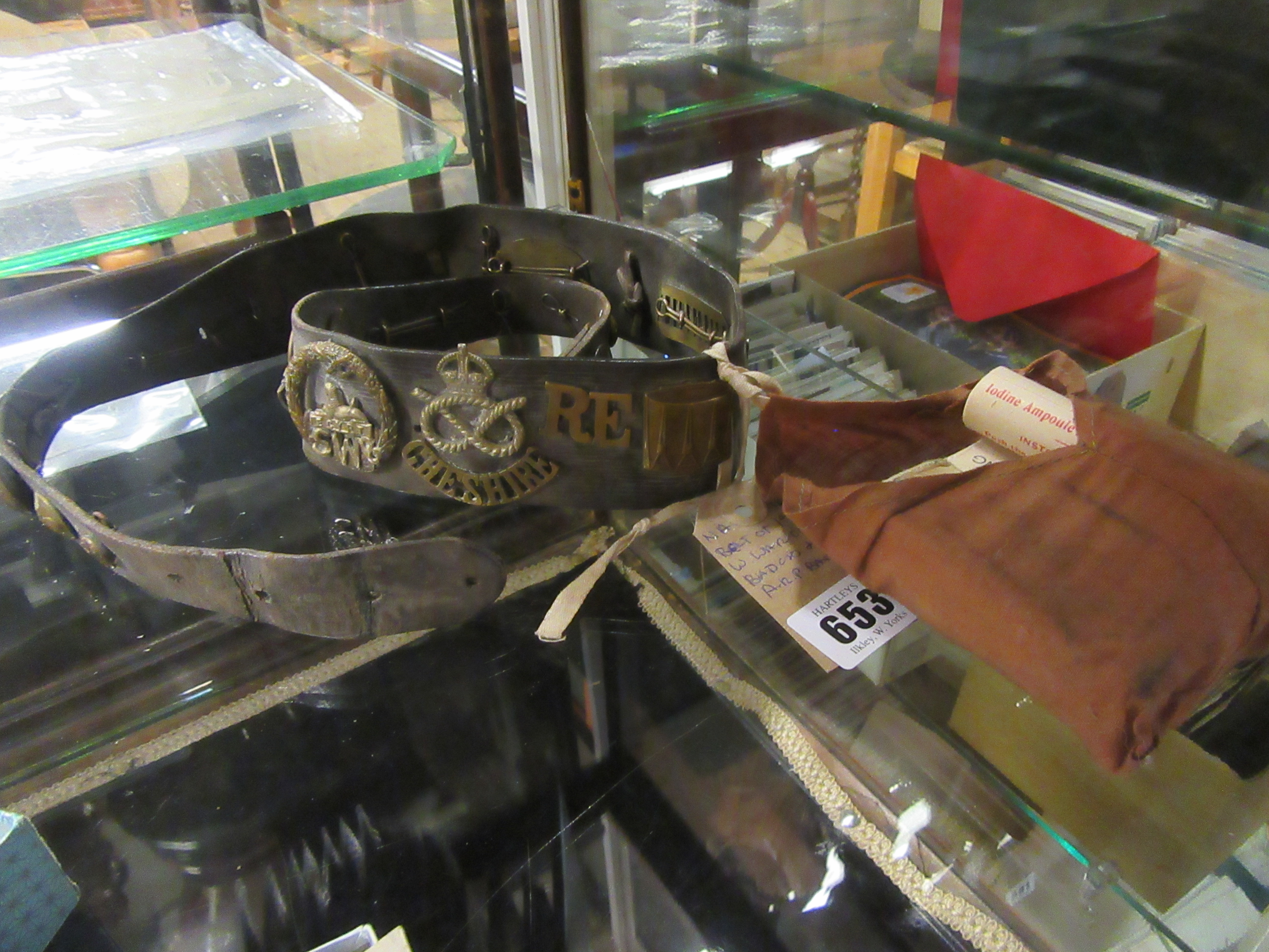 BELT OF WWI CAP BADGES AND ARP MEDICAL DRESSINGS Image