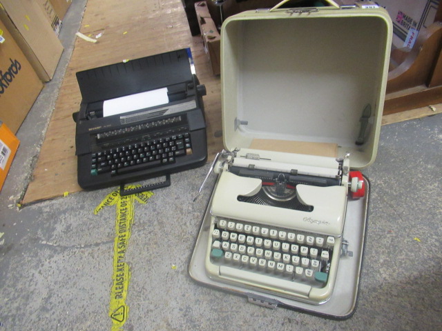CASED OLYMPIA TYPEWRITER AND SHARP ELECTRIC TYPEWRITER Image