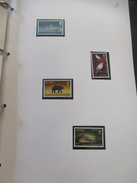 TWO RED ALBUMS OF GUERNSEY AND JERSEY MINT STAMPS Image