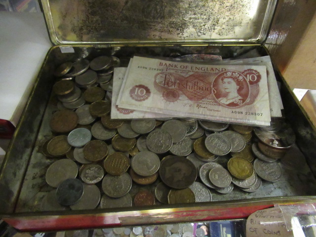 VINTAGE BISCUIT TIN OF COINS AND TEN SHILLING BANK NOTES Image