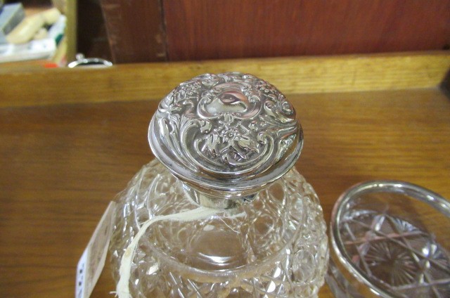 SILVER TOPPED BOTTLE AND A SILVER RIMMED DISH Image