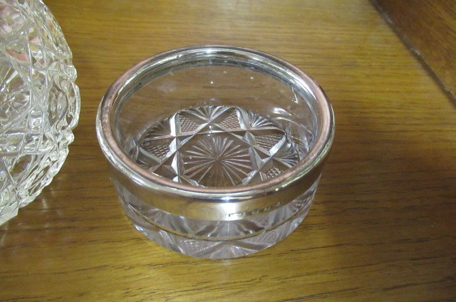 SILVER TOPPED BOTTLE AND A SILVER RIMMED DISH Image