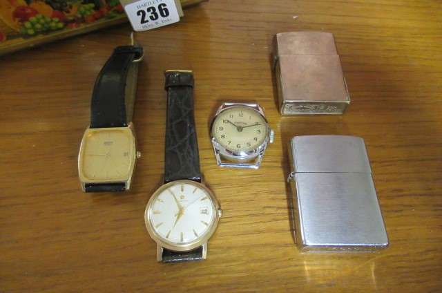 TIN CONTAINING THREE WATCHES AND TWO LIGHTERS Image