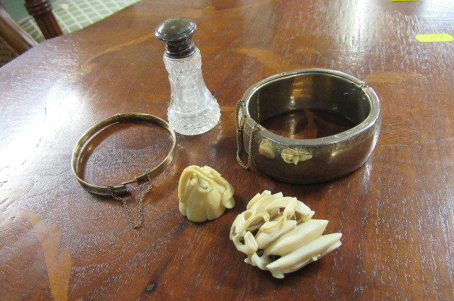 TWO NETSUKES   TWO BRACELETS AND A SILVER TOPPED SCENT BOTTLE Image