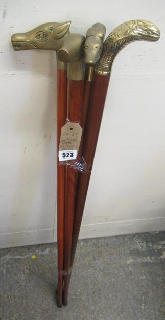 FOUR BRASS TOPPED WALKING STICKS Image