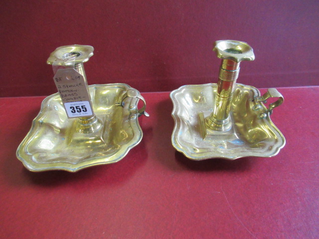 TWO SIMILAR BRASS CHAMBERSTICKS Image