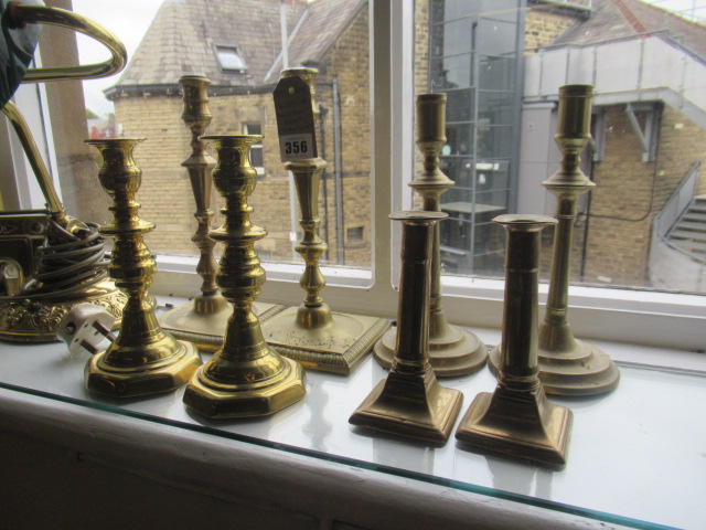 FOUR PAIRS OF ANTIQUE BRASS CANDLESTICKS Image