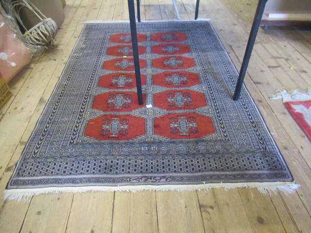 RED AND BLACK PATTERNED FRINGED RUG Image