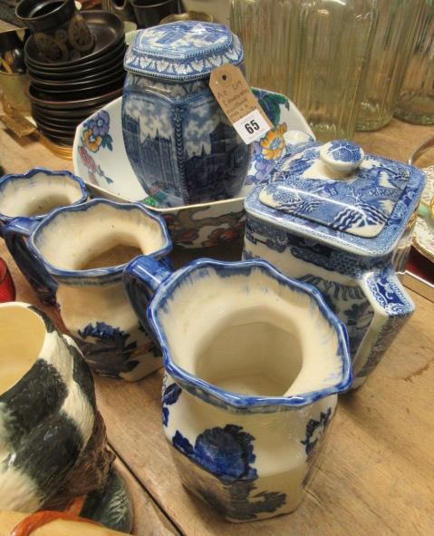 THREE GRADUATED IRONSTONE JUGS AND RINGTONS TEAPOT VASE AND A BOWL Image