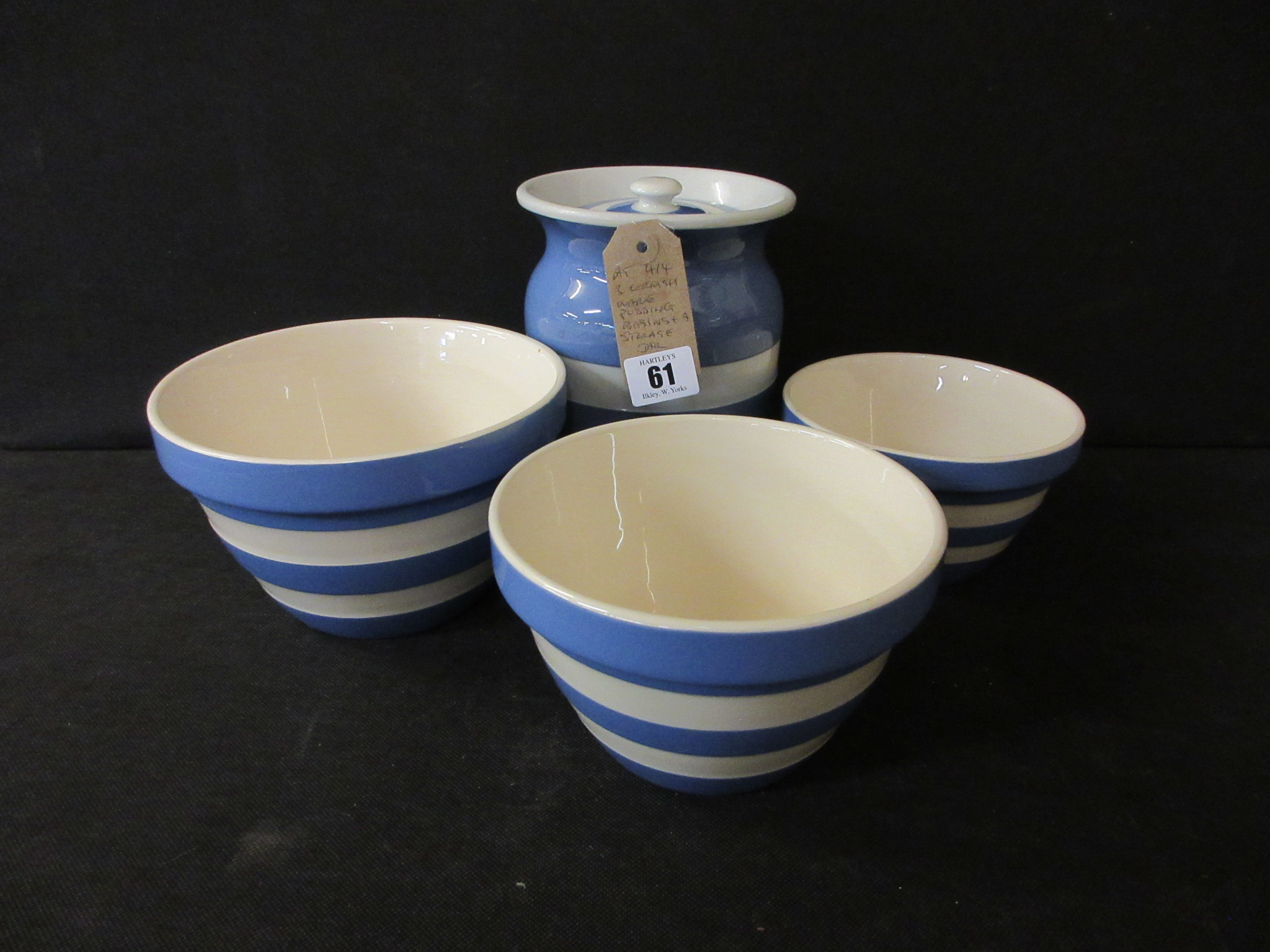 THREE CORNISHWARE PUDDING BASINS AND A STORAGE JAR Image