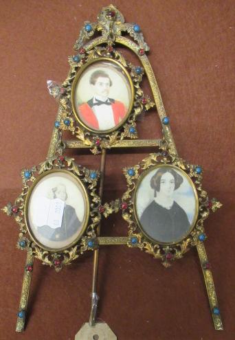 THREE MINIATURE PORTRAITS IN ORNATE EASEL FRAME Image