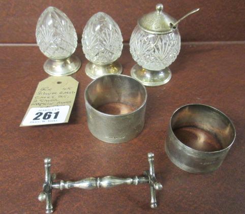SILVER BASED CRUET SET  TWO SILVER NAPKIN RINGS AND ANOTHER Image