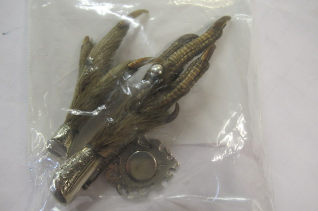 TWO SILVER MOUNTED CLAW BROOCHES AND A SILVER MEDAL Image