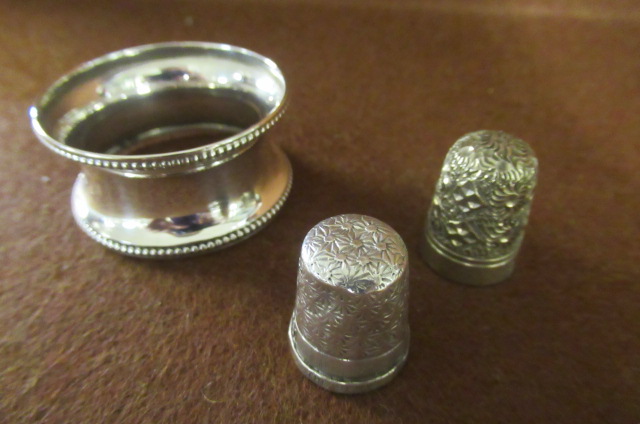 SILVER NAPKIN RING AND TWO THIMBLES Image