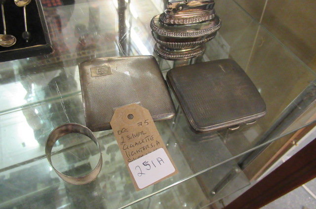TWO SILVER CIGARETTE CASES  SILVER NAPKIN RING  AND A LIGHTER Image