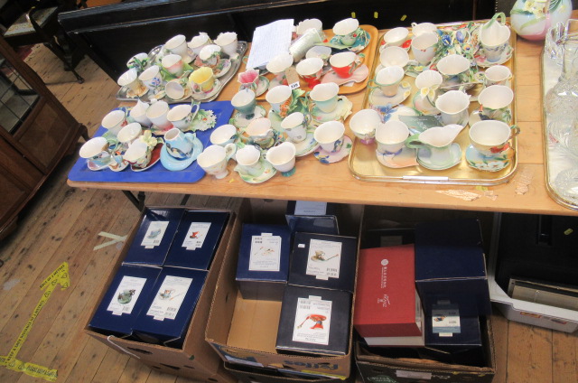 LARGE COLLECTION OF FRANZ PORCELAIN FLOWER CUPS SAUCERS AND SPOONS.  Image