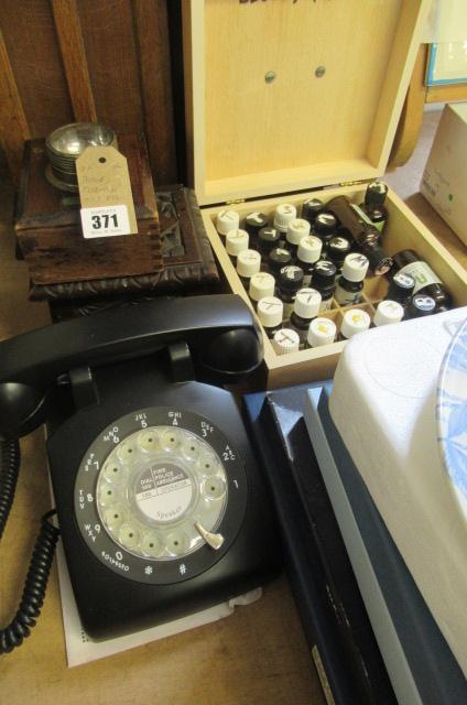 A PHONE  ESSENTIAL OILS AND A LAMP Image