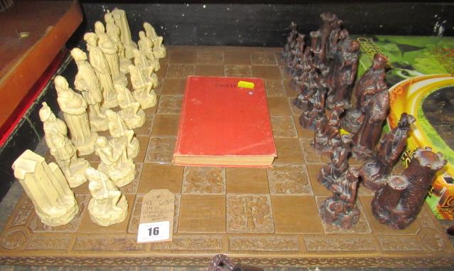 CHESS BOARD WITH PIECES AND A CHESS BOOK Image