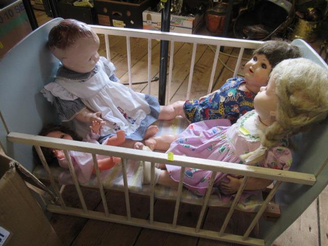 FOUR DOLLS AND A COT Image