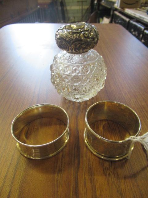 TWO SILVER NAPKIN RINGS AND A PERFUME BOTTLE Image