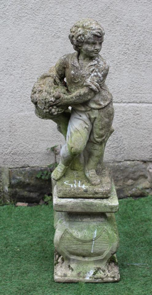 A CAST STONE ALLEGORICAL FIGURE AUTUMN, modelled as a youth holding a basket of fruit, raised on a Image