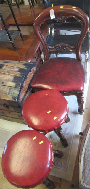 RED LEATHER UPHOLSTERED CHAIR AND A PAIR OF SIMILAR STOOLS Image