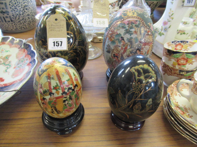 FOUR PORCELAIN EGGS WITH STANDS Image
