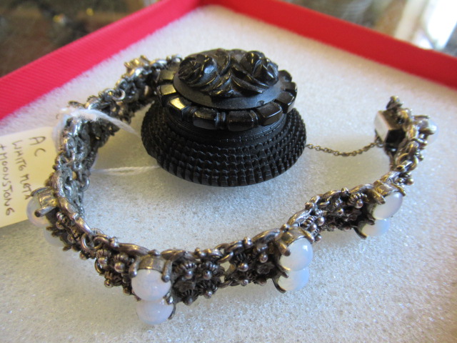 WHITE METAL AND MOONSTONE BRACELET AND A BOGWOOD BROOCH Image