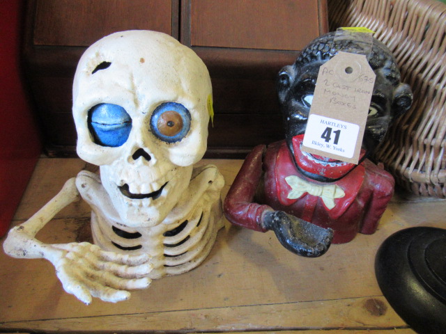 A CAST IRON NOVELTY SKULL MONEY BOX AND AN ALUMINIUM EXAMPLE Image