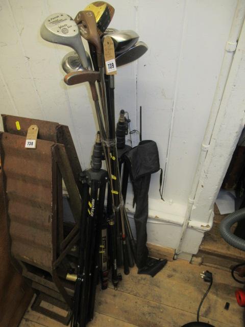THREE CAMERA TRIPODS AND GOLF CLUBS Image