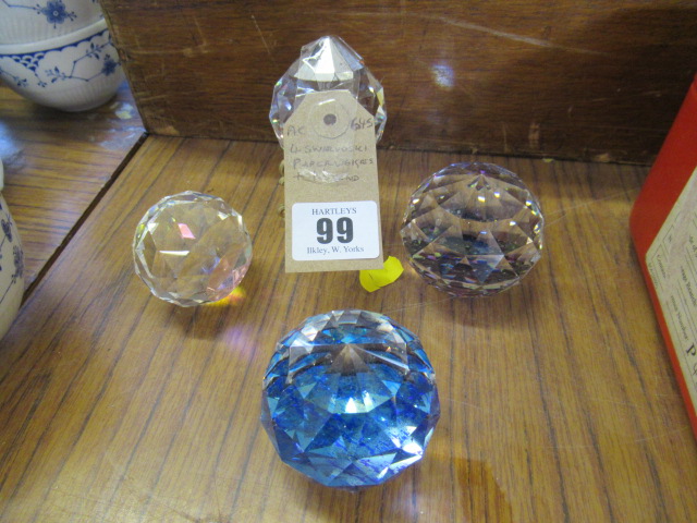 FOUR SWAROVSKI PAPERWIEGHTS AND A STAND Image