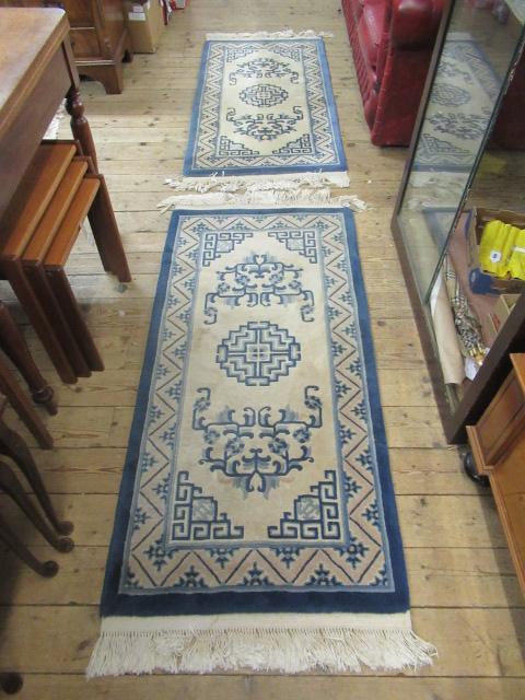 THREE BLUE PATTERNED RUGS Image