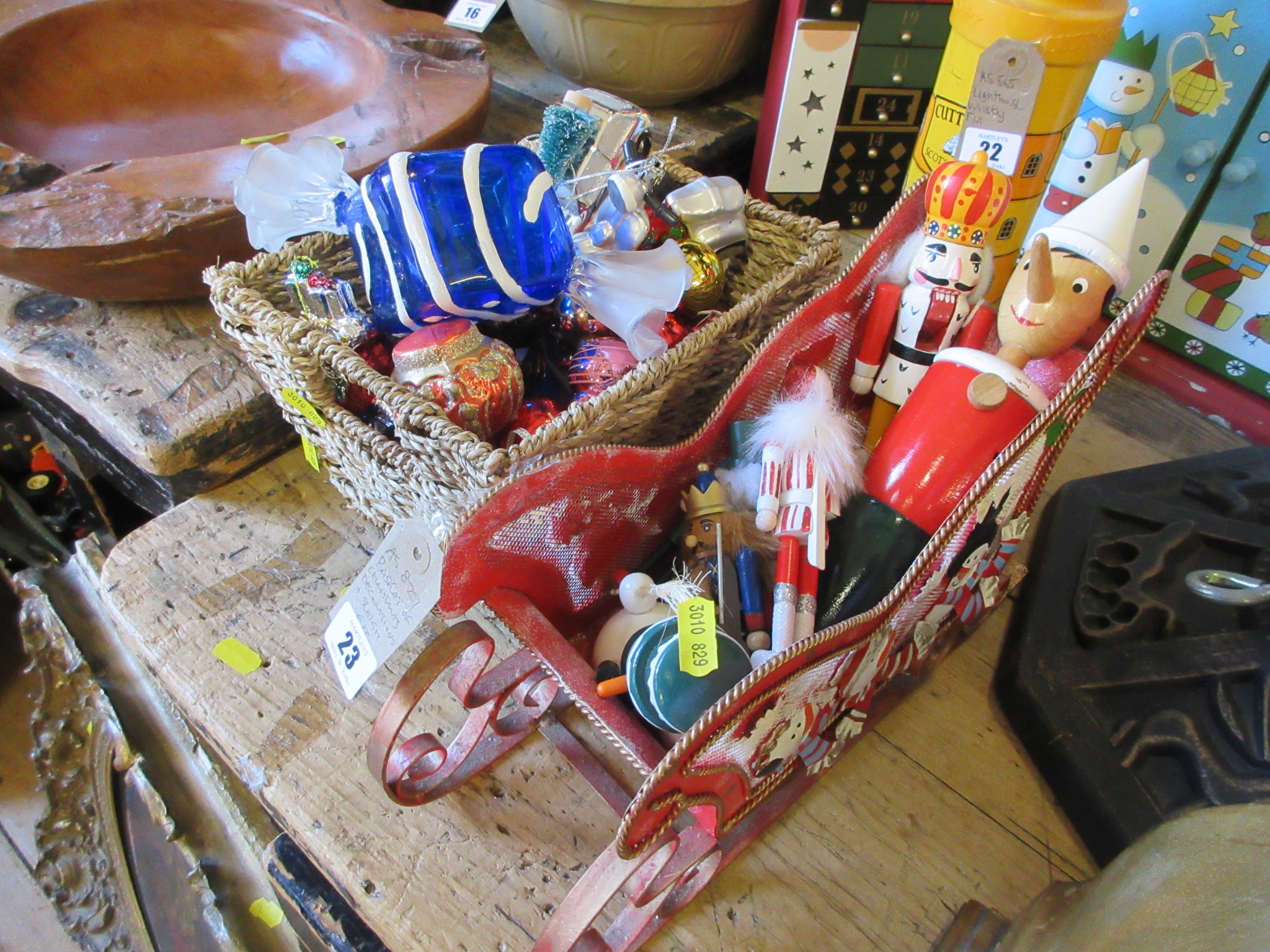 BASKET OF CHRISTMAS DECORATIONS AND SLEIGH Image