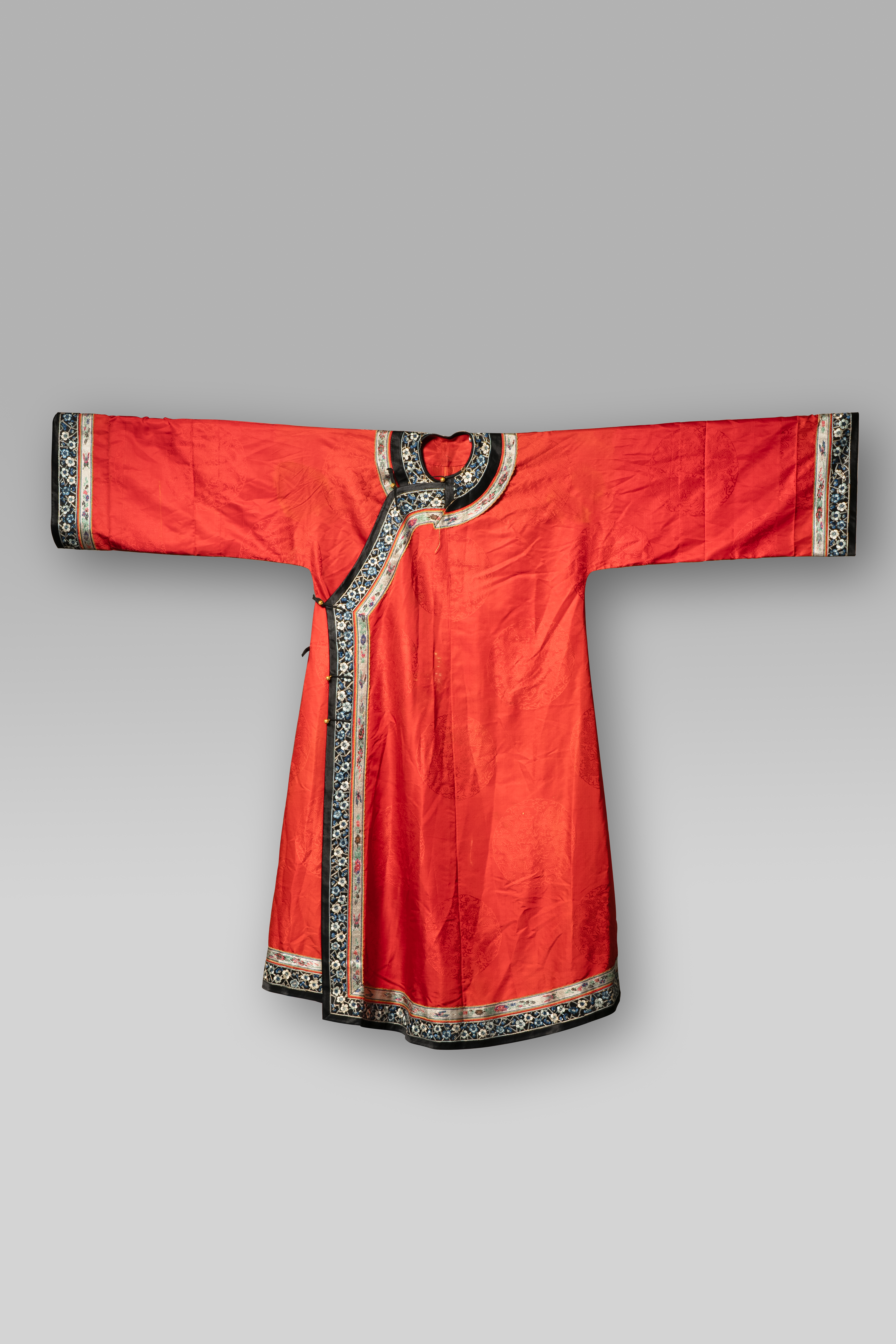 A CHINESE RED SILK 'DRAGON' ROBE