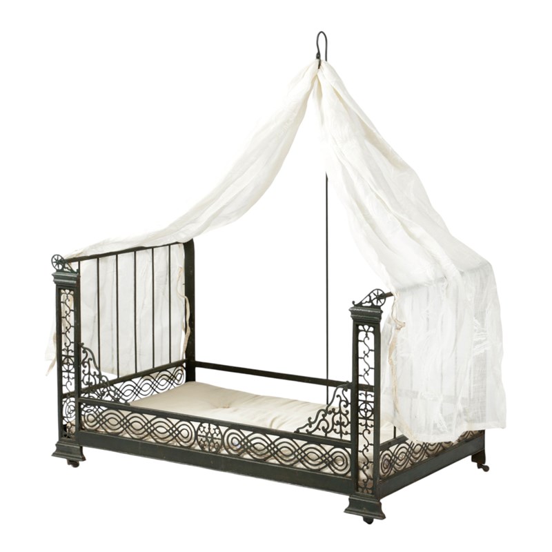 A french cut brass dolls day bed Woolley and Wallis