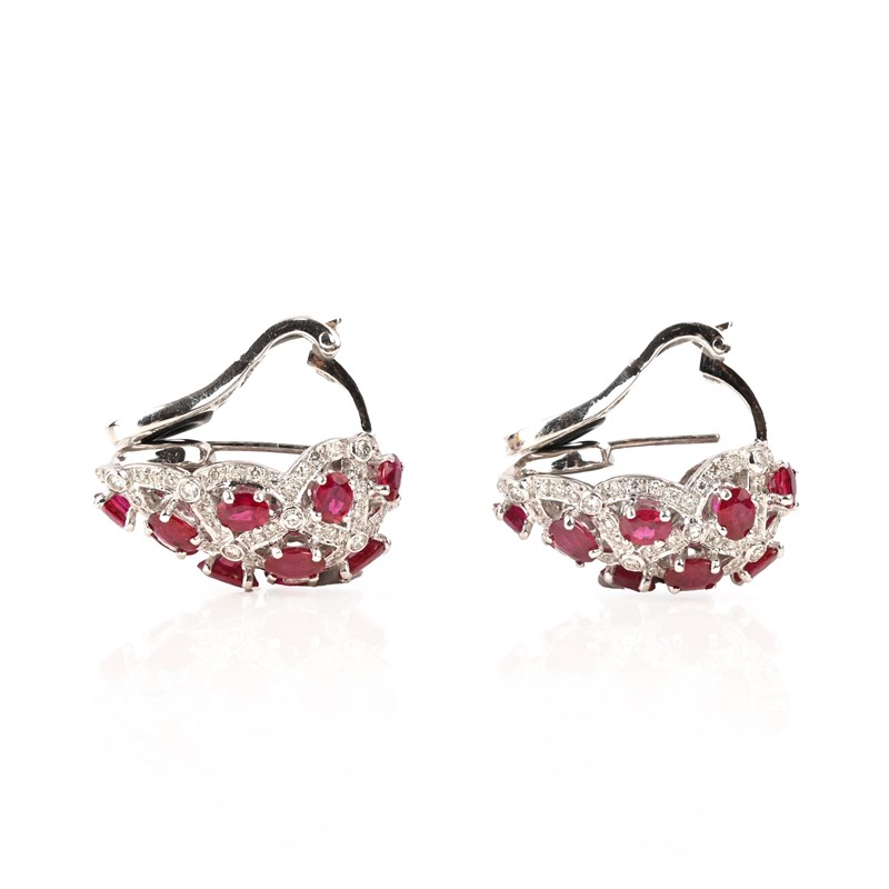 A pair of ruby and diamond earclips | Woolley and Wallis