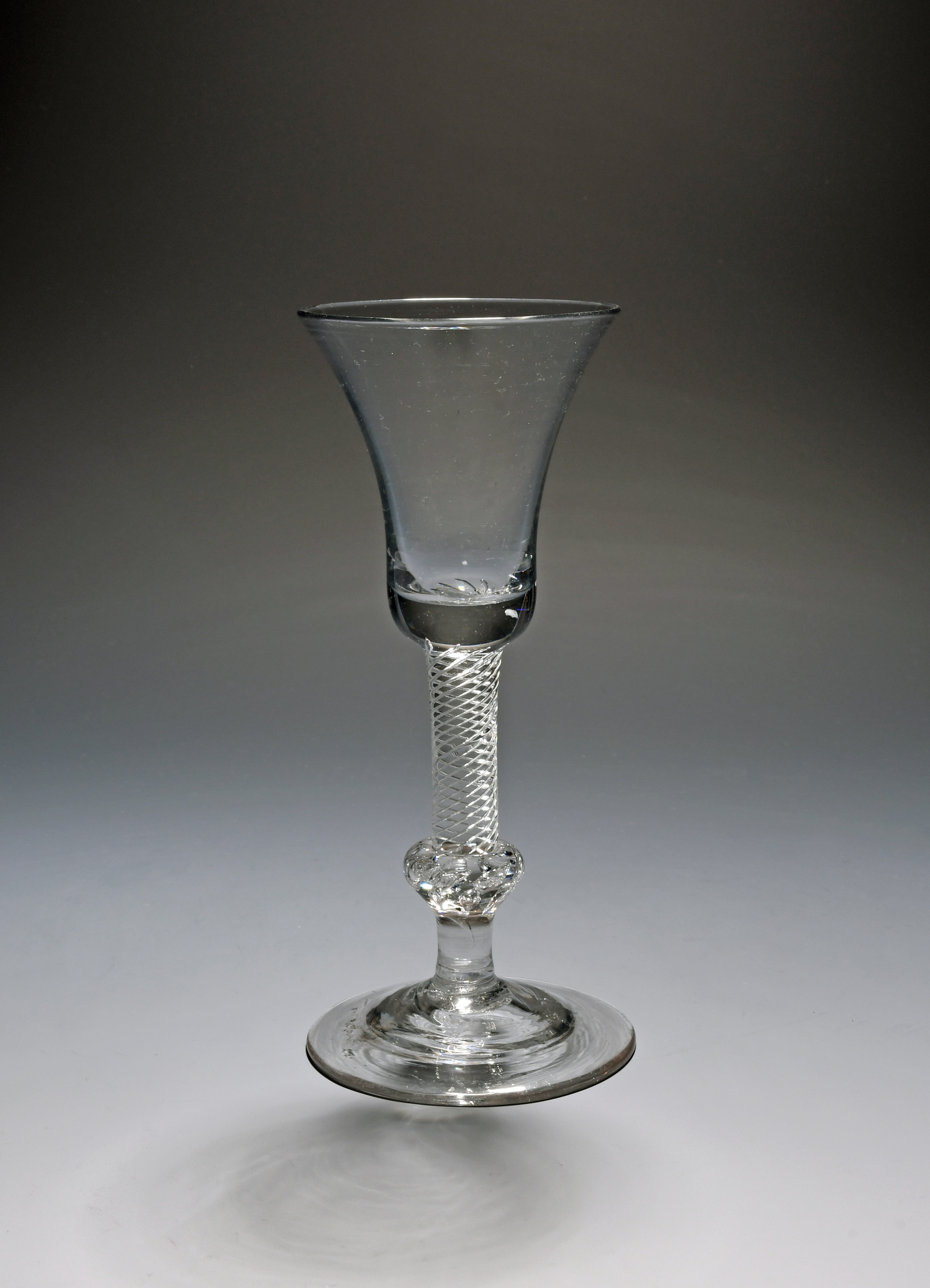 A composite stem wine glass, c.1750, the bell bowl raised on an airtwist...