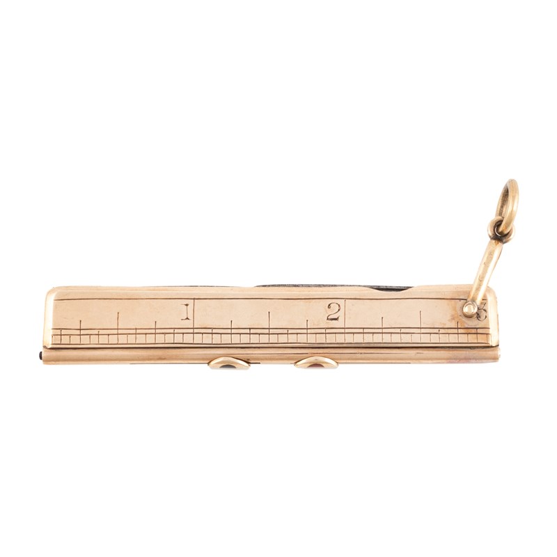 A Gold Ruler An early-20th century gold combination ruler with two pencils ...