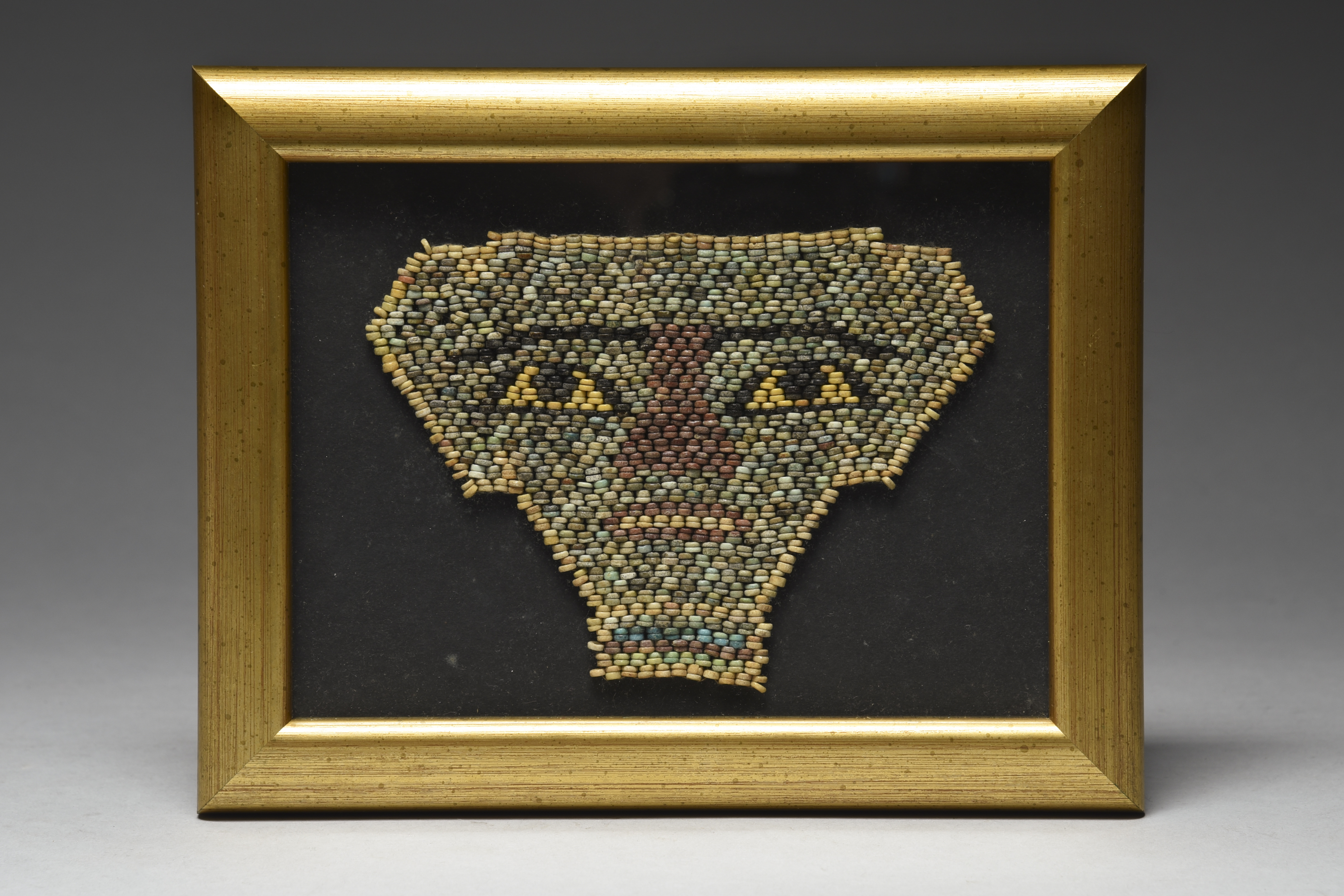 An Egyptian glazed composition mummy bead mask