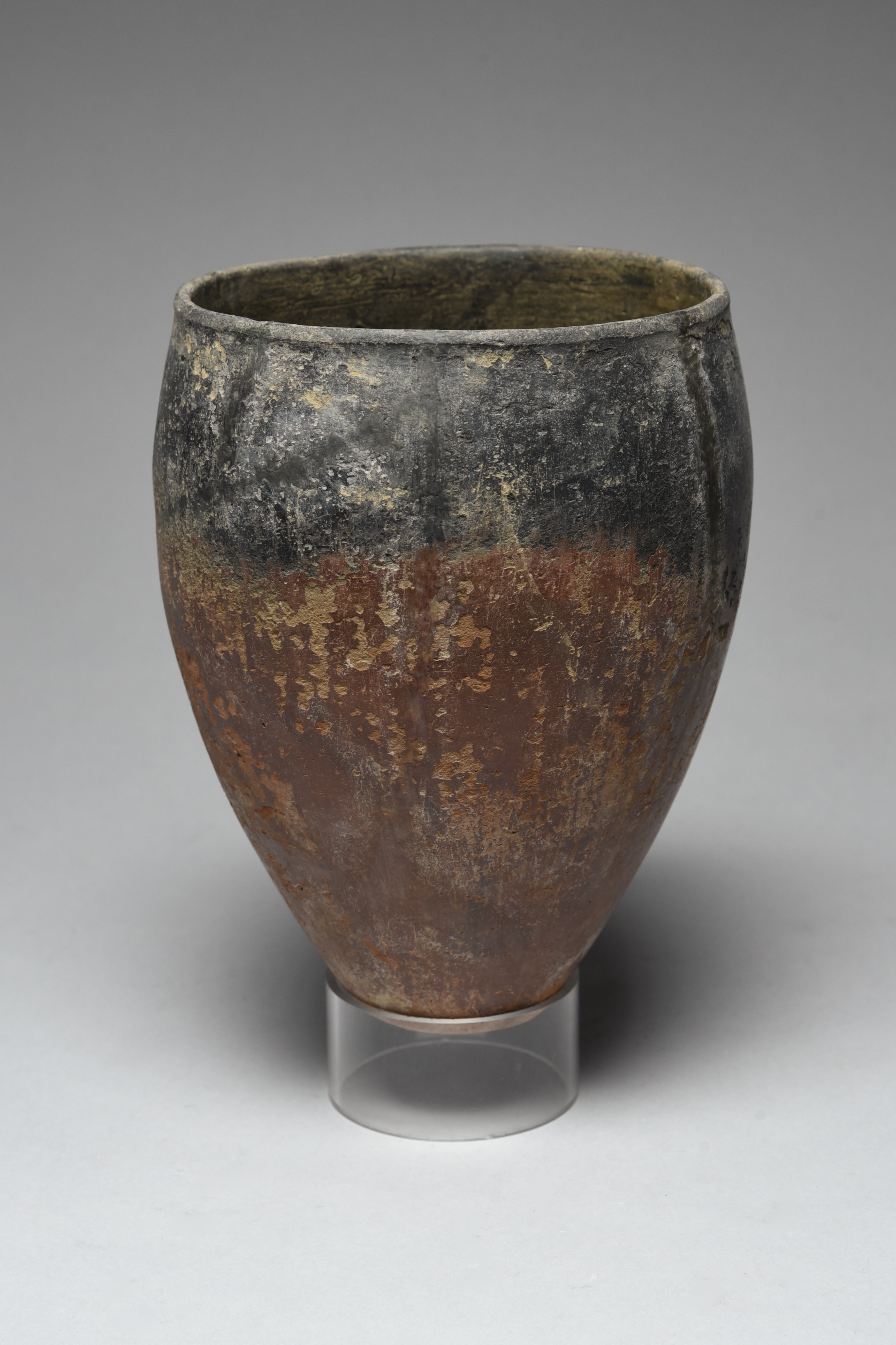 An Egyptian black topped pottery jar